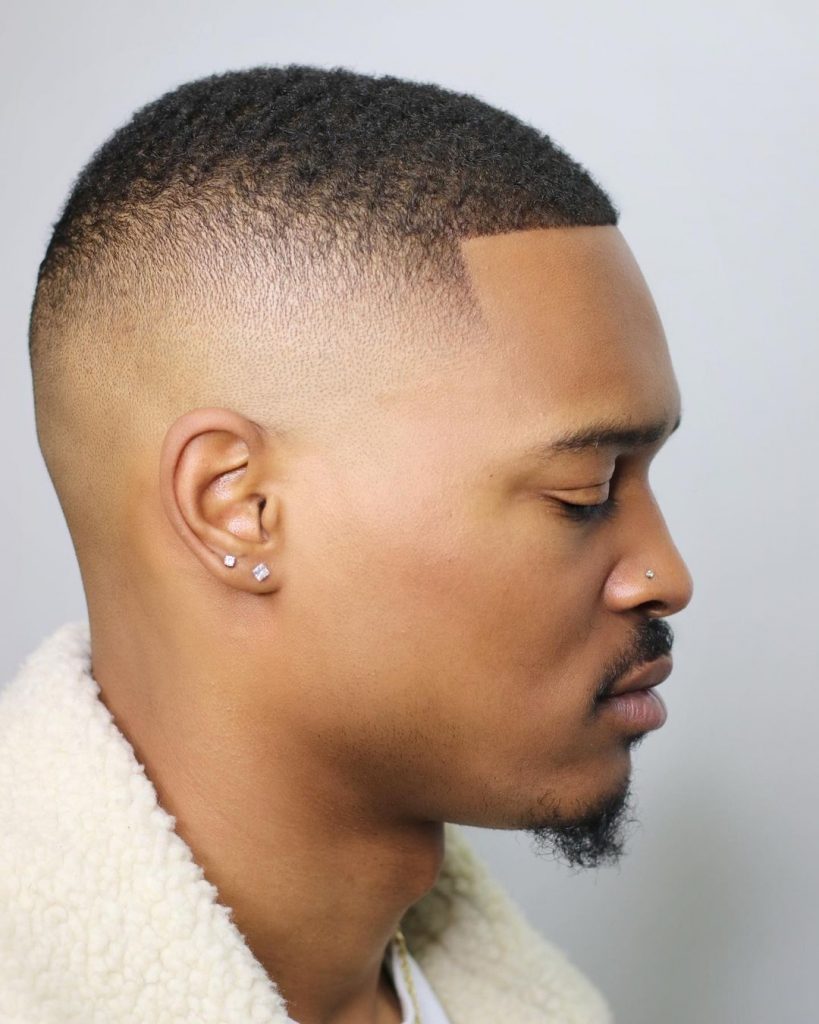 Men's high fade haircut with waves