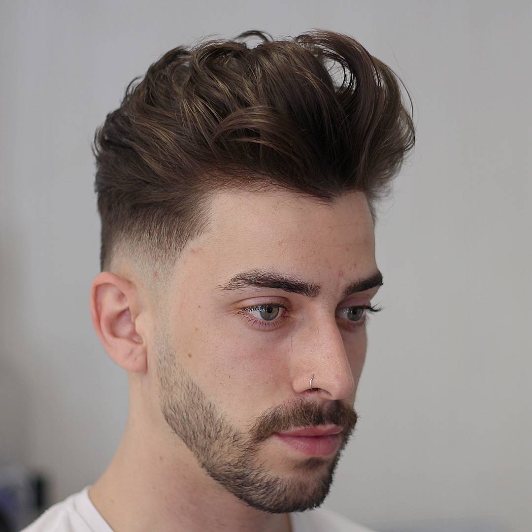 Low fade and medium wavy hair hairstyle for men