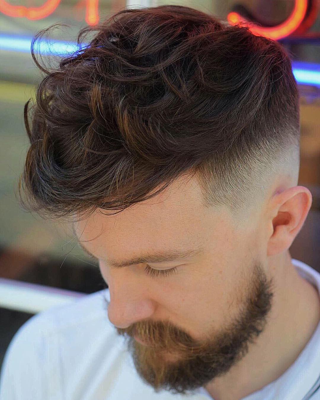 Medium length textured hairstyle for men and bald fade