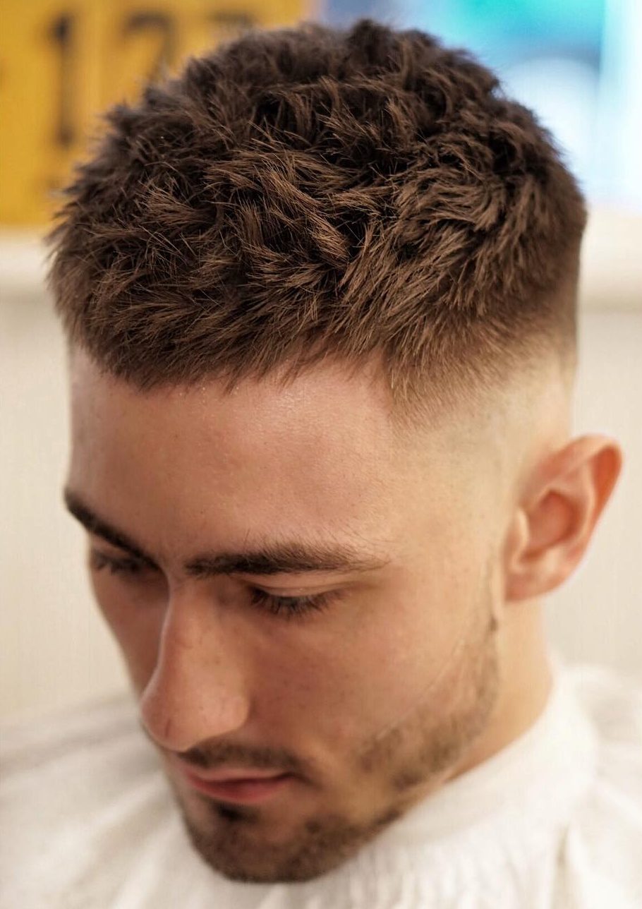 Short haircut for men with spiky textures and high fade